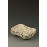 A JAPANESE CALLIGRAPHIC SETO WARE DISH by Shunzan (Kato Kagenori) of waisted rectangular form with