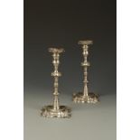 A PAIR OF GEORGE III CAST CANDLESTICKS with pull-off shaped square sconces, turned cylindrical