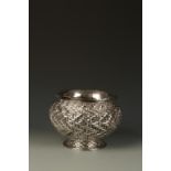 A JAPANESE WHITE METAL BOWL of bellied circular form, with all over basket weave decoration, on a