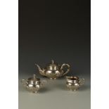 A CHINESE THREE PIECE TEA SET of bellied circular form with bamboo style handles and finials,