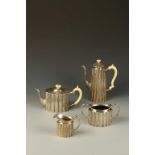 A VICTORIAN FOUR PIECE TEA/COFFEE SET of fluted oval form, with ivory scroll handles and finials,