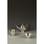 A THREE PIECE TEA SET of circular tapering form, the teapot with wooden scroll handle and finial, on