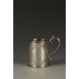 A VICTORIAN CHRISTENING MUG of circular form, with a beaded scroll handle, the body with engine-