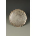 MILITARY INTEREST: A PRESENTATION SALVER of shaped circular form, with a gadrooned border,