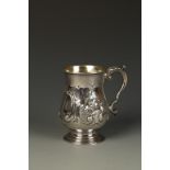 A VICTORIAN MUG of baluster form with leaf capped scroll handle and gilt interior, the body embossed