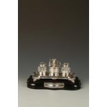 AN EDWARDIAN PRESENTATION INK STAND of shaped rectangular form with shell borders, on down-curving