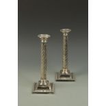 A PAIR OF VICTORIAN SPIRAL FLUTED COLUMN FORM CANDLESTICKS with detachable sconces and square beaded