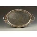 A LARGE TWO-HANDLED TRAY of oval form, with an egg and dart border, the pierced handles modelled