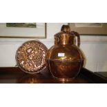 A large copper Guernsey milk churn and a similar copper mould