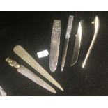 A collection of assorted white metal letter openers