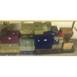 A large collection of Chinese boxes with various fabric coverings