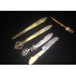 A carved mother-of-pearl letter opener and a collection of similar items