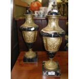 A pair of early 20th century black marble and ormolu mounted urns