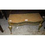 A 19th century brass trivet with a fretwork panel and scroll feet