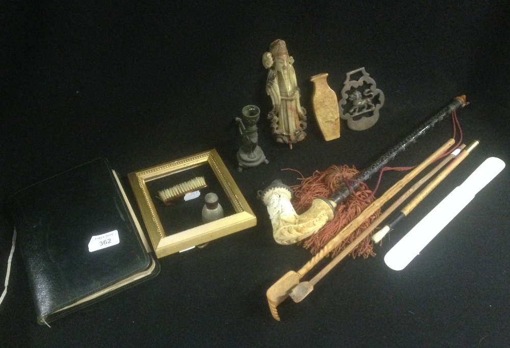 A Meerschaum pipe, carved with figures smoking pipes, with a metal wirework decorated tube, and