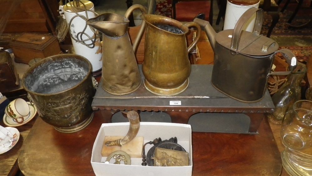 A Victorian brass watering can, two brass water jugs, horse brass and other metalware