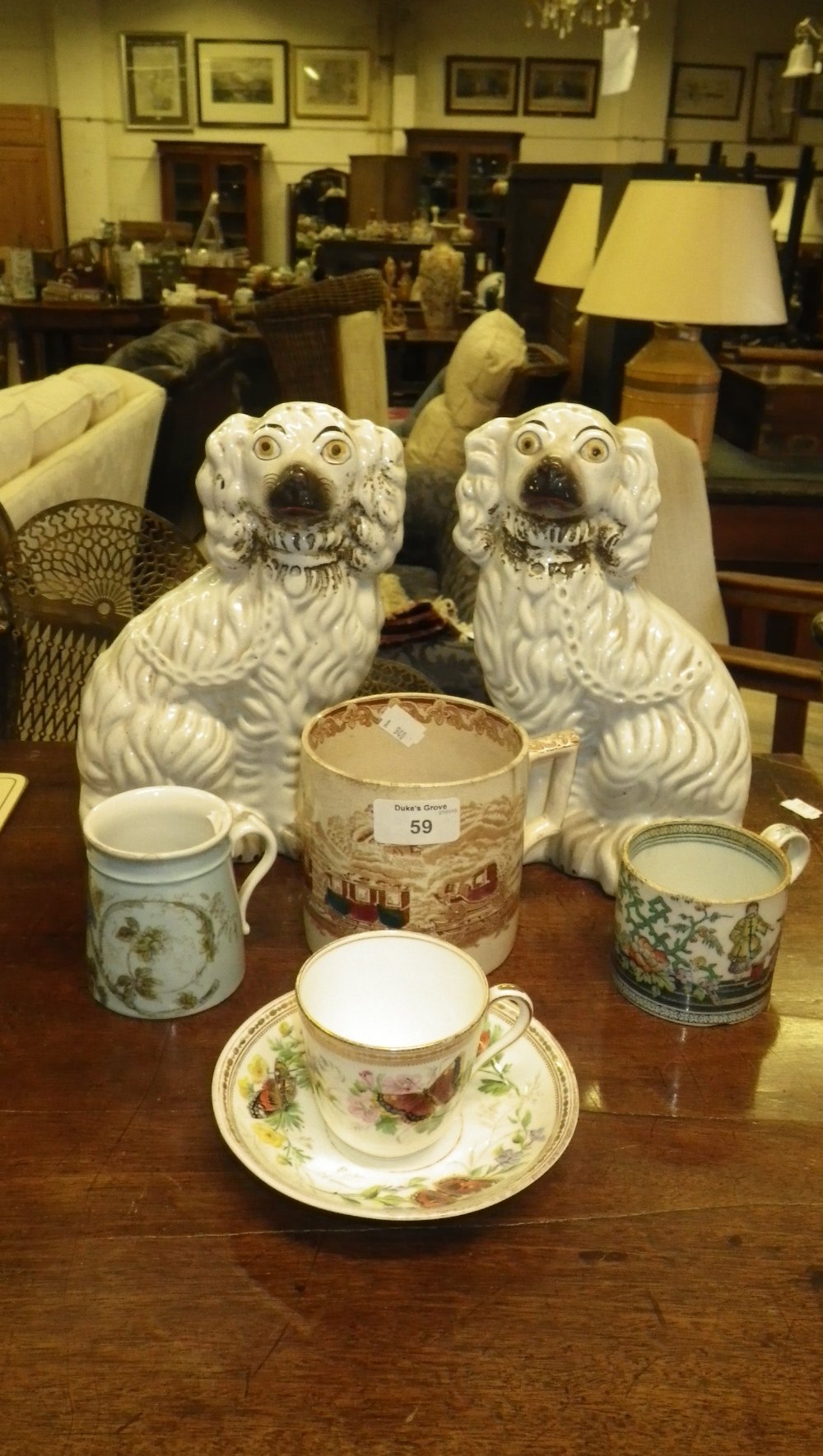 A pair of Staffordshire dogs, a 19th century transfer decorated mug depicting early railway