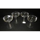 A set of Edwardian cut-glass champagne bowls with hollow stems