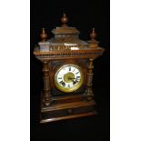 A late 19th century walnut-cased mantel clock