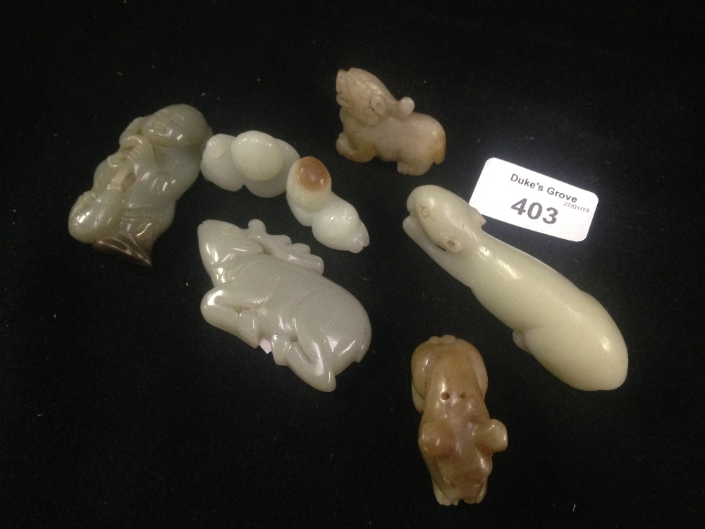 A pale celadon 'Jade' figure of a recumbent rodent and other similar animals