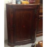 A George III mahogany corner cabinet