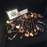 A large collection of assorted wooden pipes of various forms