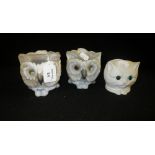 An Edwardian bisque night light in the form of a cat and two others similar