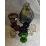 A collection of coloured eye baths and similar glassware