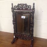 An Oriental hardwood and mother of pearl inlaid dressing mirror