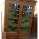 A George III mahogany corner cabinet with glazed upper astragal doors and panelled doors below