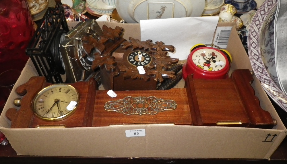 A cuckoo clock, a miniature grandfather clock and similar clocks