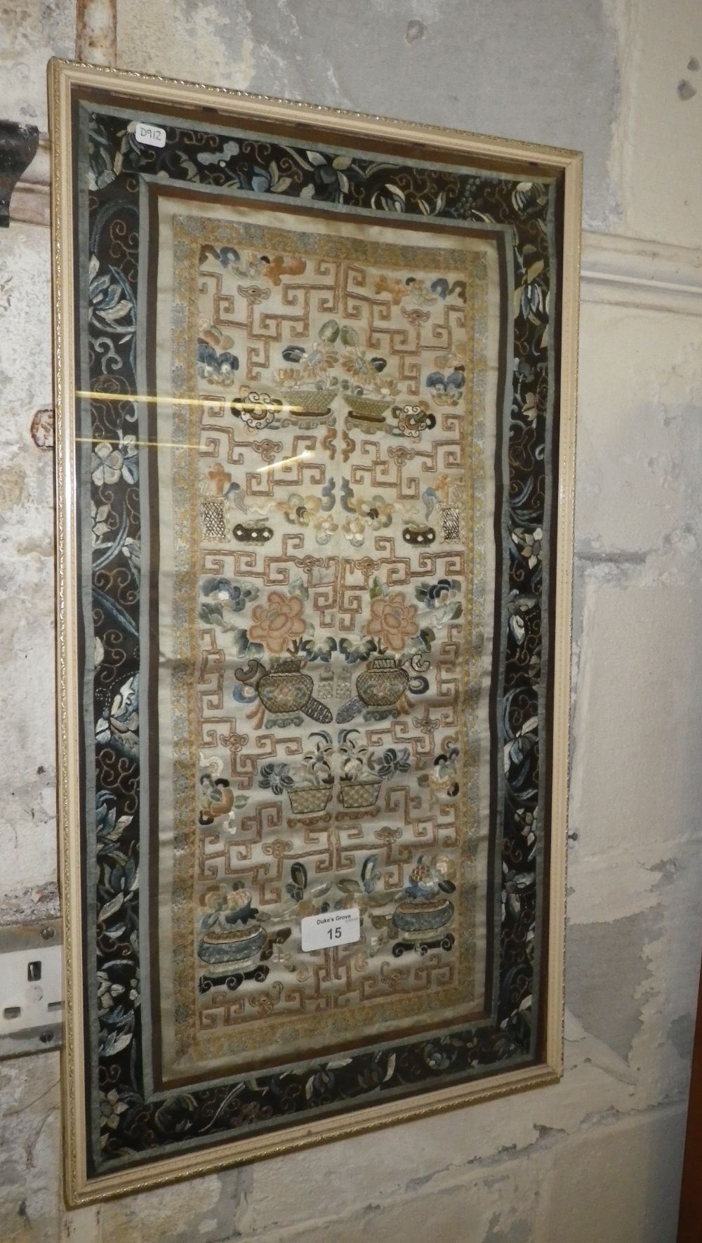 An Oriental embroidery (framed) and a famille-jaune mug