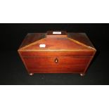 A George III inlaid mahogany sarcophagus-shaped tea caddy with twin compartments and glass mixing