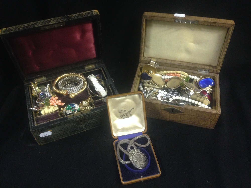 Two leather-bound jewellery boxes, each containing mixed costume jewellery including a silver