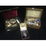 Two leather-bound jewellery boxes, each containing mixed costume jewellery including a silver