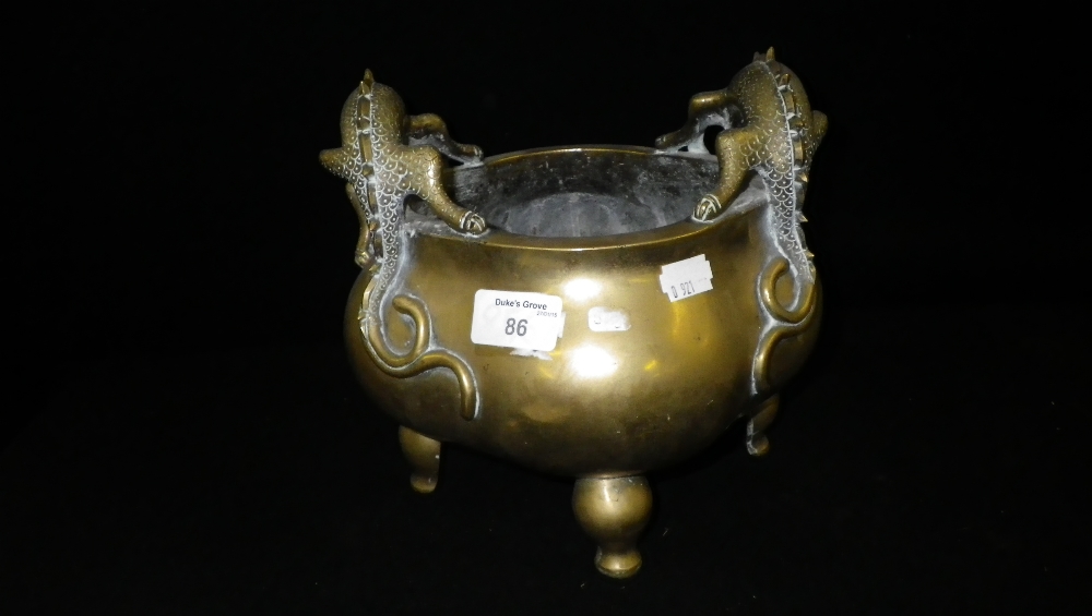 A Chinese bronze censer of quatrefoil shape decorated with stylised dragons