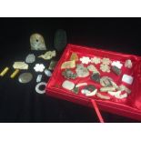 A case of mixed carved Asian hardstone pendants and toggles