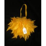 A purse, all over decorated in orange feathers