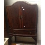 A mahogany bowfronted cabinet on stand with cabriole legs