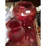 A large cranberry glass shade and similar glassware