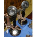 A vintage candlestick telephone and another similar