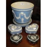 A Wedgwood blue Jasperware jardiniere and four similar Wedgwood boxes