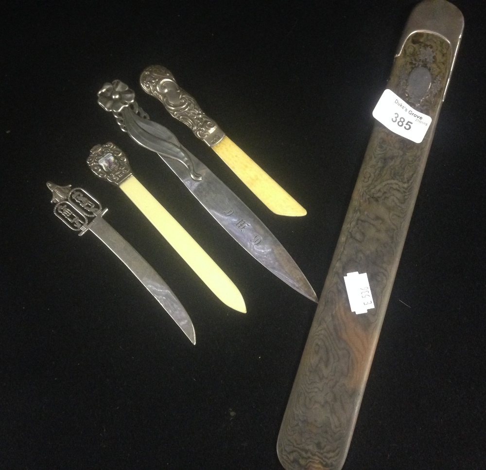 A tortoiseshell and silver inlaid page turner and four small letter openers