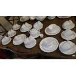 A collection of Royal Crown Derby white glazed teaware and six similar teacups with gilt handles