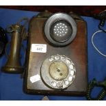 A wall mounted walnut cased vintage dial telephone, number 121