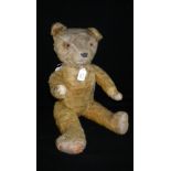 A vintage plush teddy bear, with internal growling action and long limbs