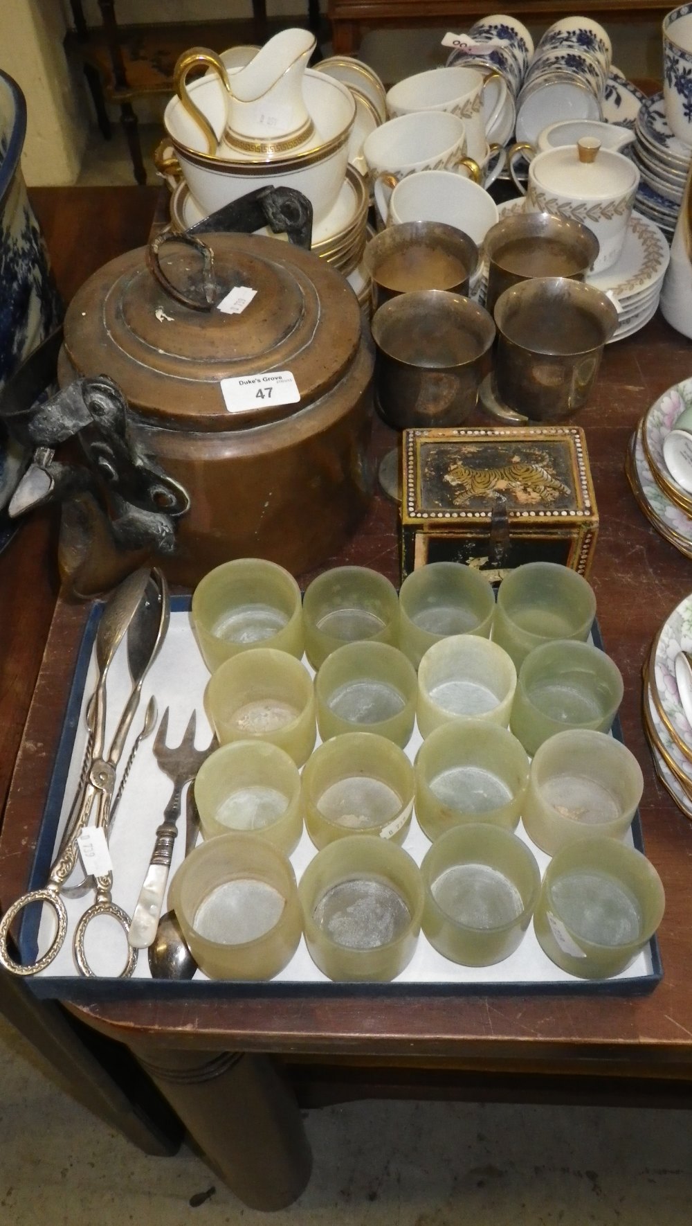 An Indian brass kettle, a collection of Chinese polished green stone beakers and similar items