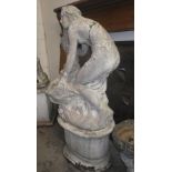 A reconstituted stone Art Nouveau study of a maiden washing her hair over a fountain, on an oval