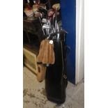 A large quantity of golf clubs contained in a golfing bag