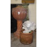 A terracotta jardiniere on stand, a similar planter and an Art Nouveau wall pocket